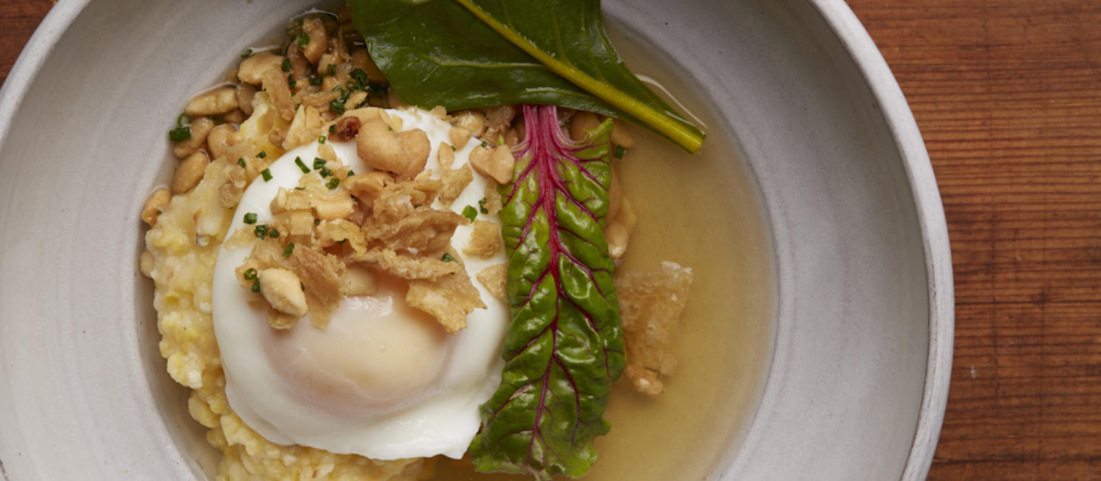 Poached Farm Egg with smoked chicken broth and Anson Mills Grits