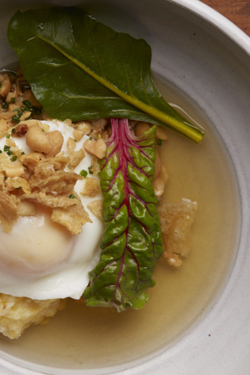 Poached Farm Egg with smoked chicken broth and Anson Mills Grits